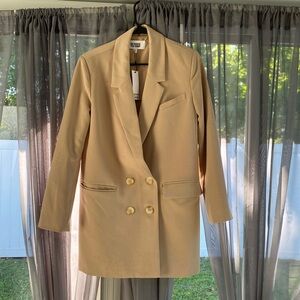 This item is a cream colored double breasted blazer size XS with original tags.